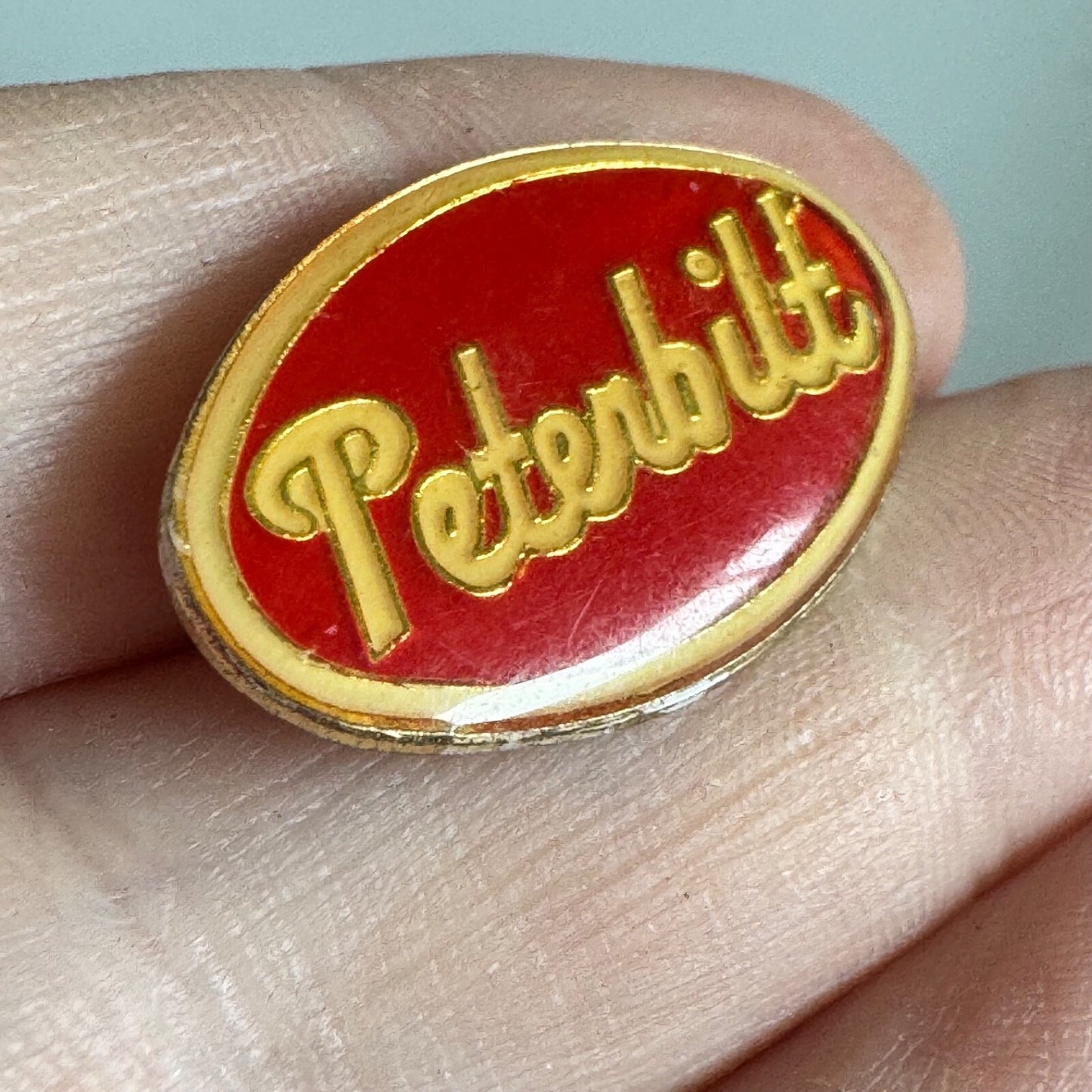 Vintage Peterbilt Logo Pin – Red & Gold Semi Truck Brand Enamel Badge