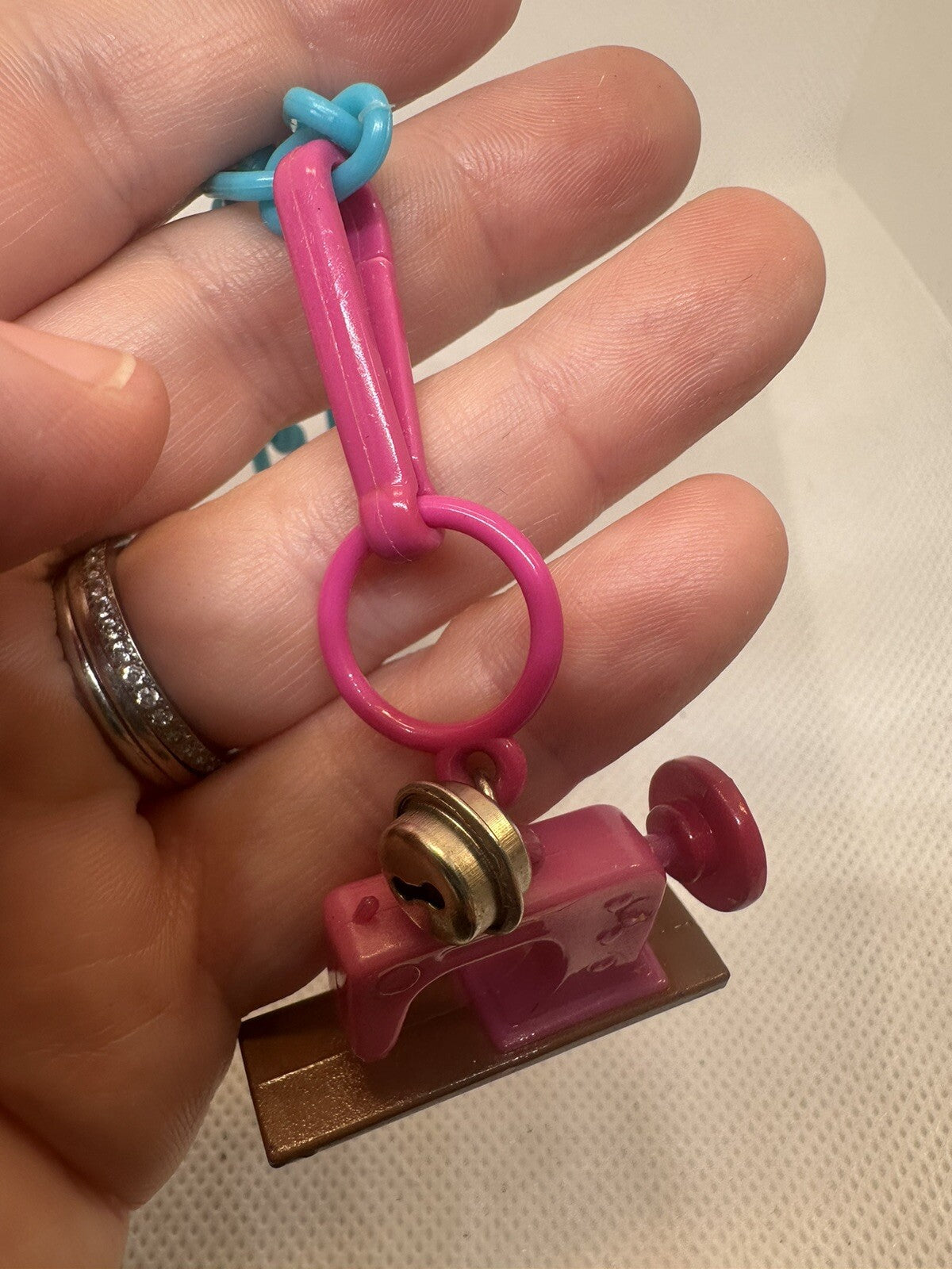 Vintage 1980s Plastic Bell Charm Pink Sewing Machine Charm Plus Blue Bracelet