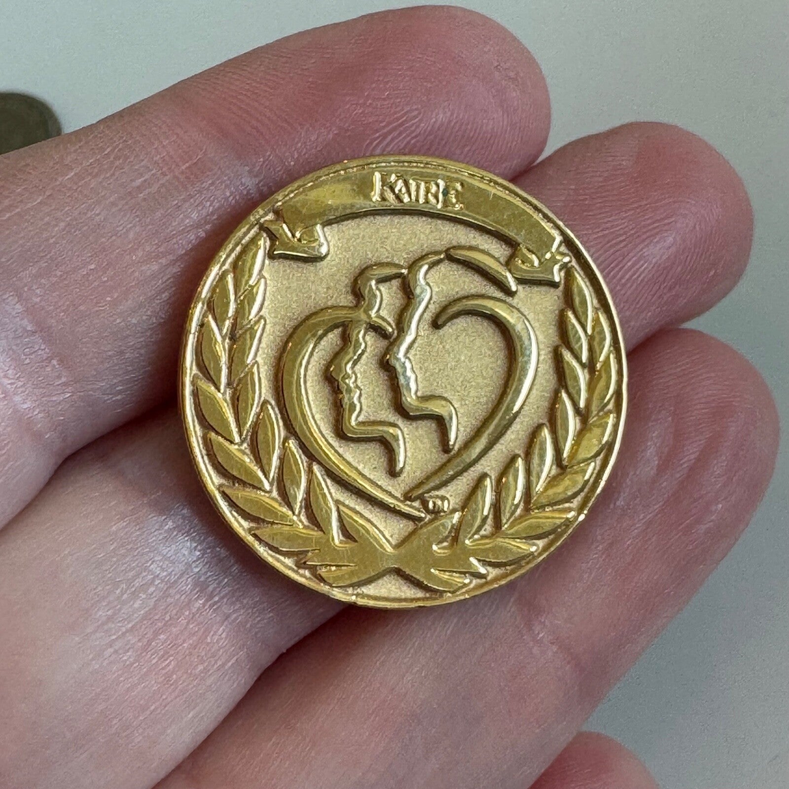 KAIRE Gold Medallion Award Pin with Silhouette Heart Supplements