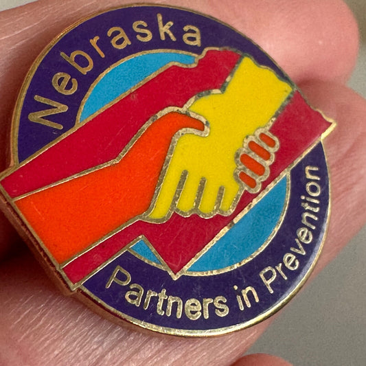 Nebraska Partners in Prevention Enamel Pin Handshake Design 