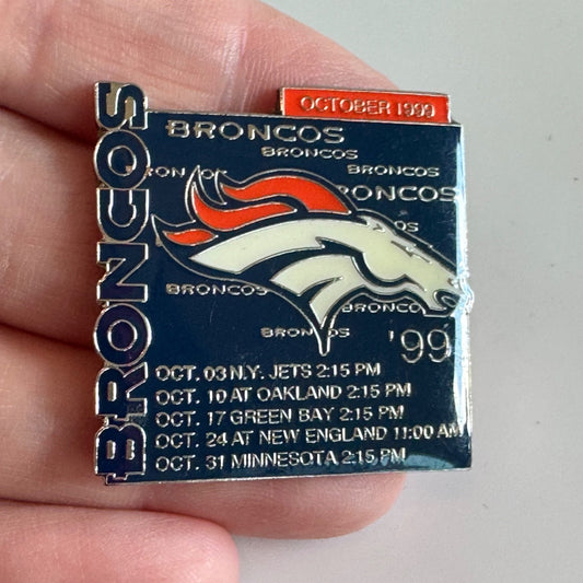 Vintage Denver Broncos October 1999 NFL Schedule Blue Enamel Football Lapel Pin