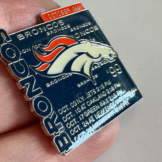 Vintage Denver Broncos October 1999 NFL Schedule Blue Enamel Football Lapel Pin